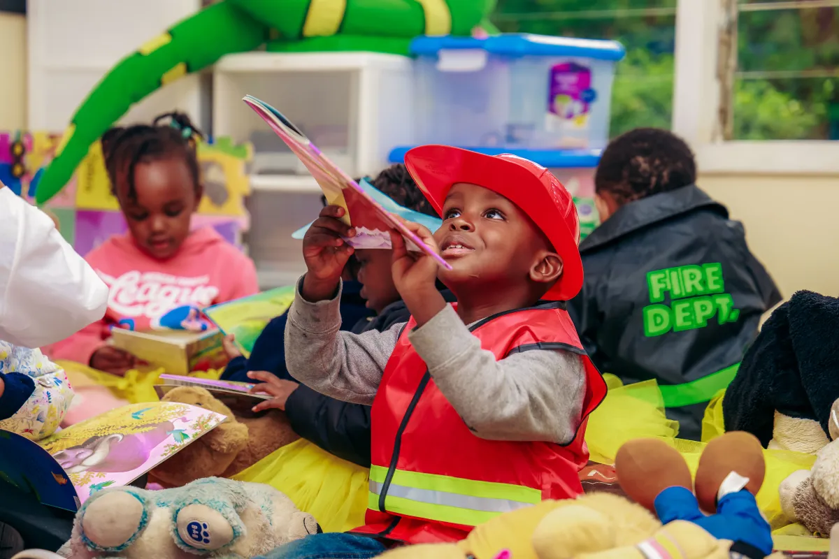 A teacher guiding an Early Years learner
